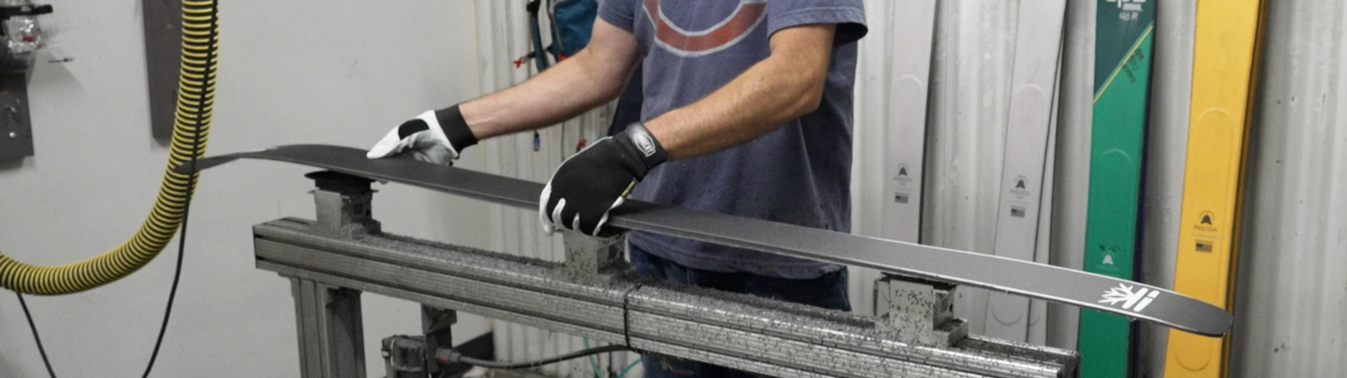 Close view of Man working on DPS skis