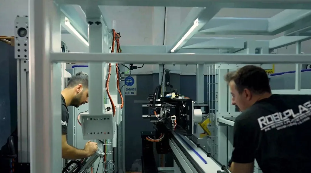 two men working with robotics