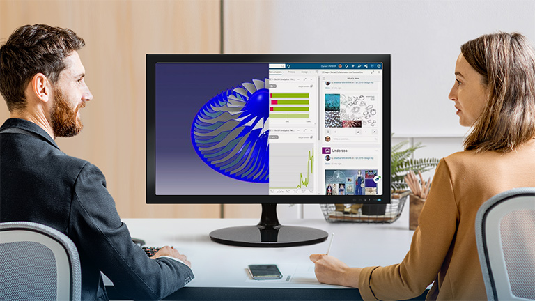 Dos compañeros hablan sobre un modelo 3D de 3DEXPERIENCE Works y datos relacionados en un monitor de escritorio