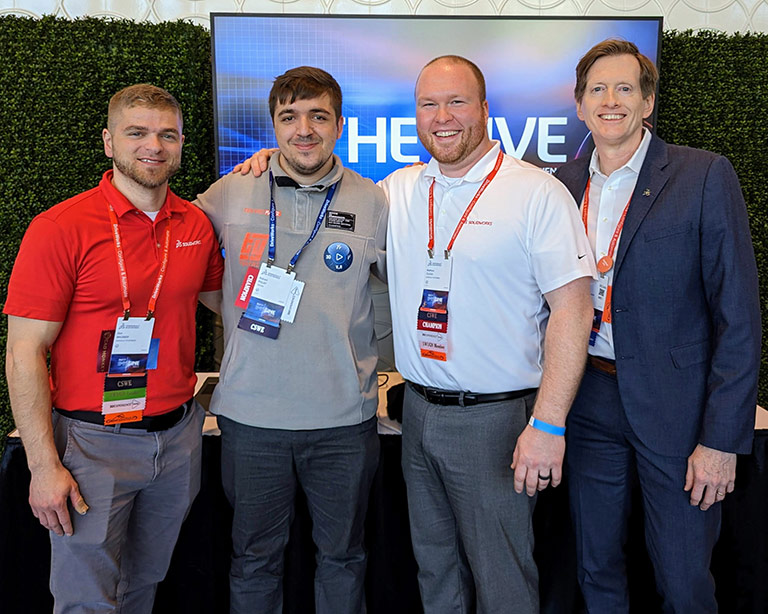 SOLIDWORKS champion with three SOLIDWORKS employees smiling