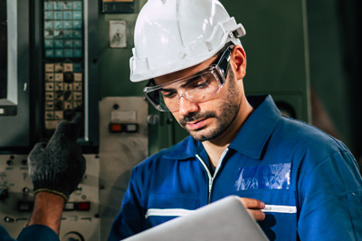 Worker at machine, using DELMIAworks