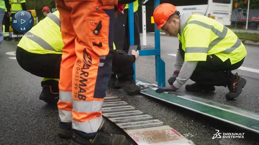 Workers installing Elonroad charging strips onto the road