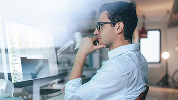Person in looking at 3D model on screen - SOLIDWORKS
