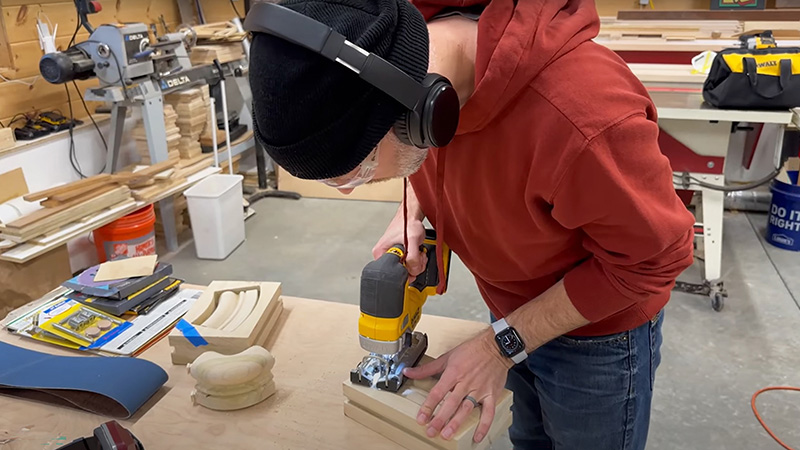 Woodworking maker cutting wood pieces designed in SOLIDWORKS for Makers