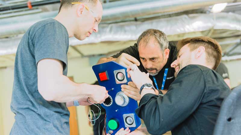 Makers assembling a robot