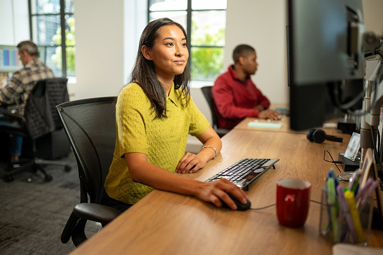 Young people at computer in office setting