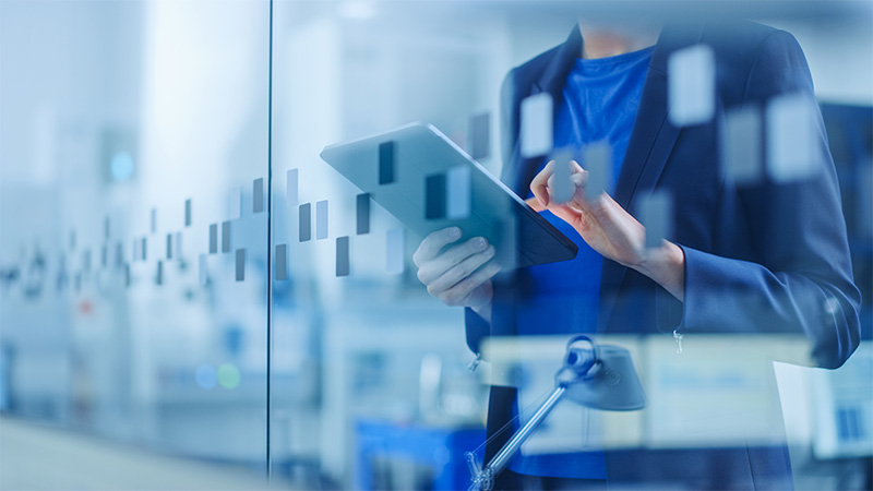 Worker in office setting with tablet