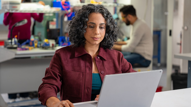 image depicting woman using electrical design software on a laptop