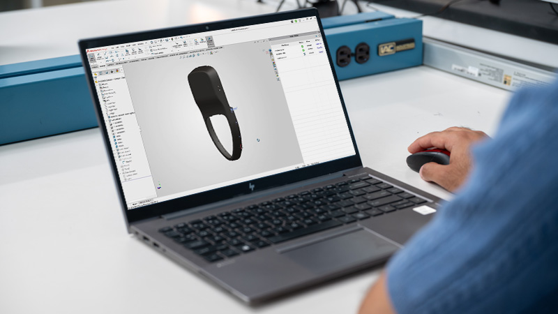 person using SOLIDWORKS Design software on a laptop computer