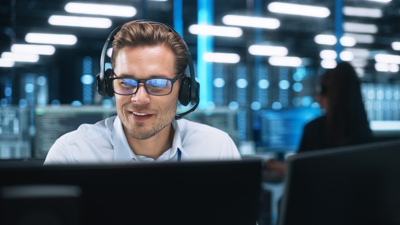 man at a computer providing virtual tech support