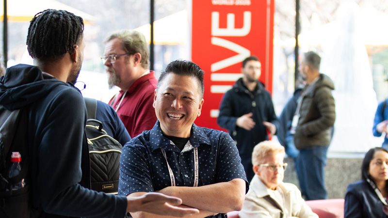 Two 3DEXPERIENCE World attendees engaged in conversation