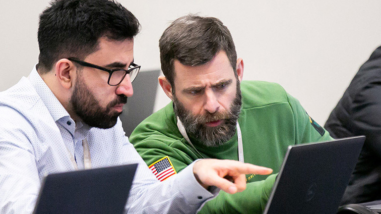 One person helping another person in a class - SOLIDWORKS