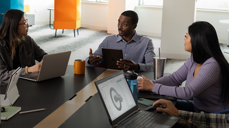 People collaborating around a table - SOLIDWORKS