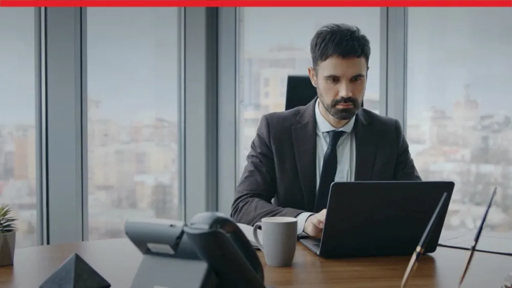 Company manager working on a laptop