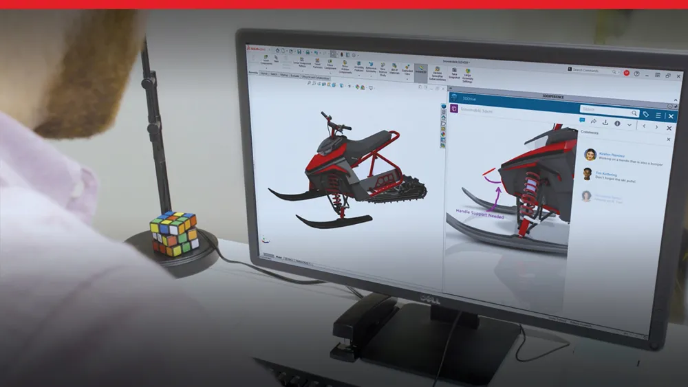 Person looking at screen with SOLIDWORKS 3D model of a snowmobile with data