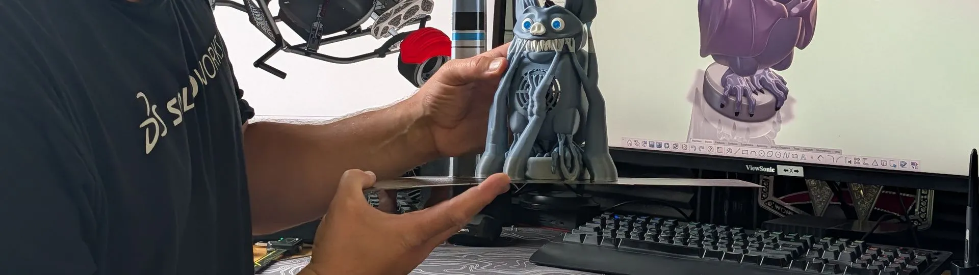 Maker in his workshop with his 3D printer and CNC machine, projects designed in SOLIDWORKS for Makers