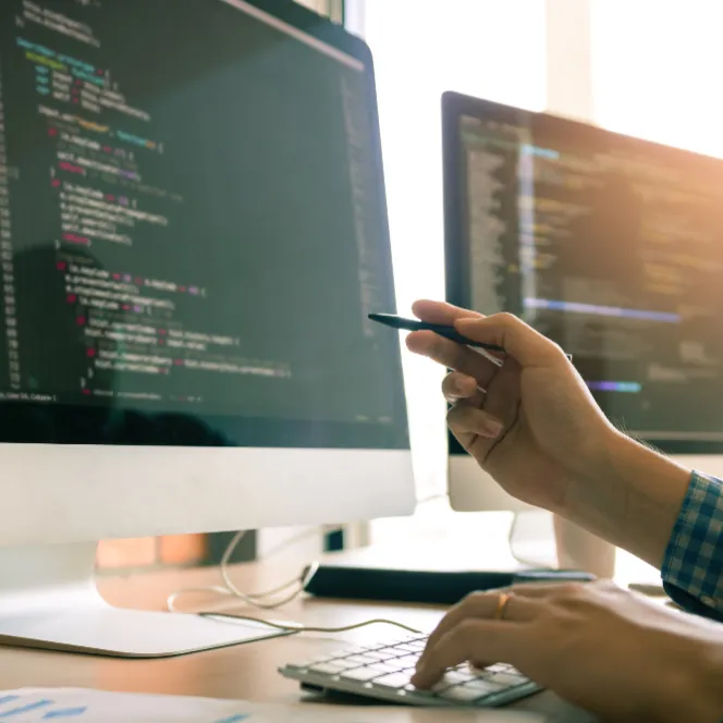 Hand pointing to data on a computer screen