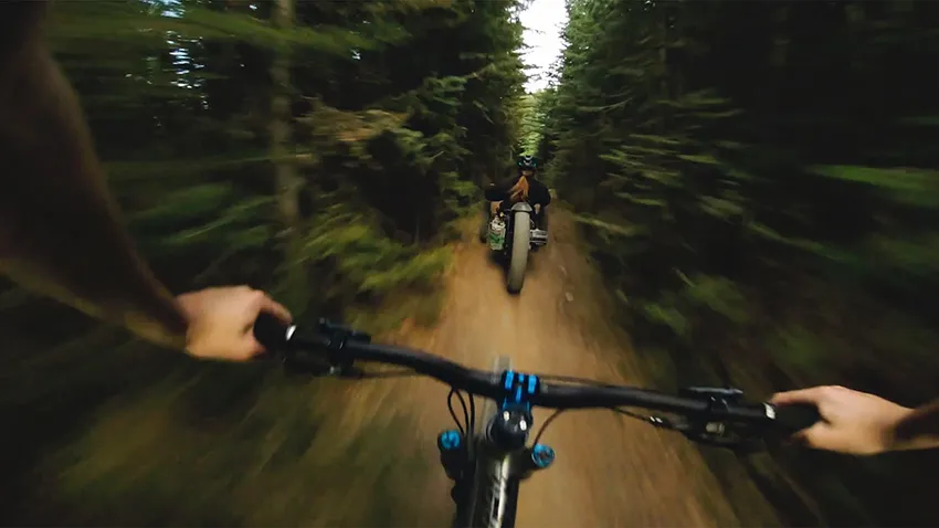 View of person on mountain bike riding behind a Bowhead wheelchair - SOLIDWORKS Cloud Services
